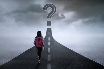 student walking down a road