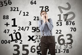 man in front of a screen with numbers