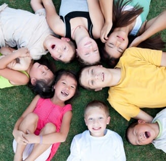 children lying on the grass