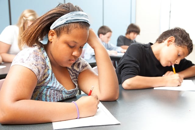 students writing in classroom